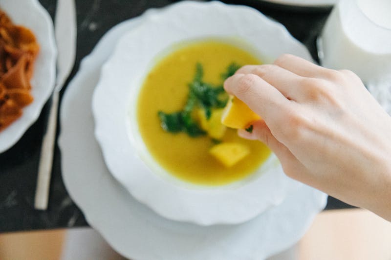 Lentil turmeric soup garnished with herbs